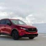 Red 2026 Mazda CX-5 in a rooftop parking lot.
