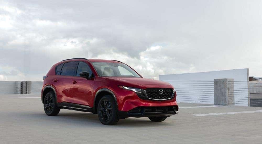 Red 2026 Mazda CX-5 in a rooftop parking lot.