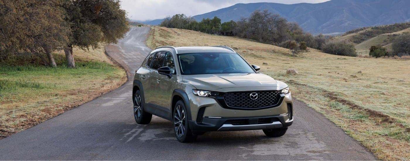 A silver 2023 Mazda CX-50 shown parked on a mountain road.