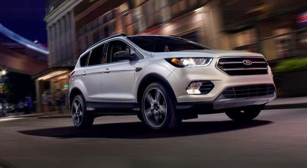 White 2019 Ford Escape driving down a road.