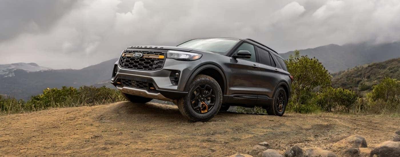 Grey 2026 Ford Explorer Tremor driving off-road on a hill.