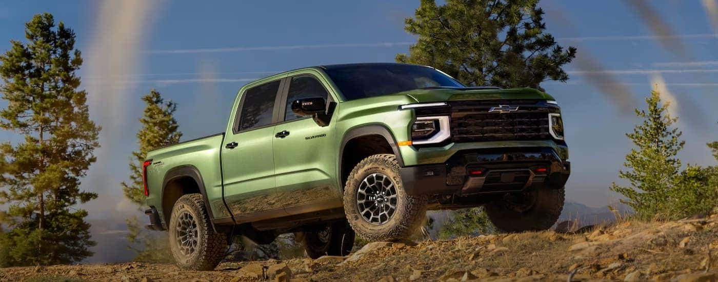 Green 2027 Chevy Silverado 1500 driving off-road.