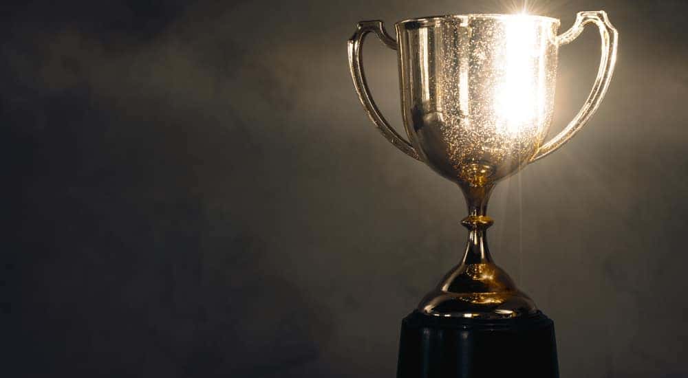 Gold, glowing trophy against a black background