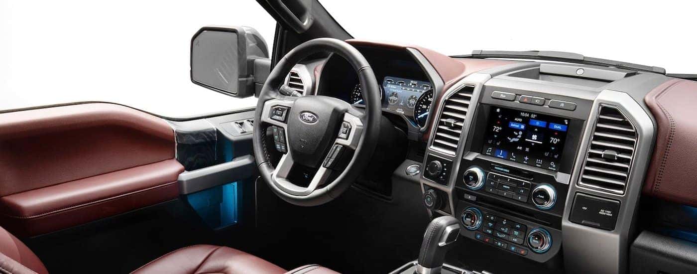 The black and brown interior of a 2018 Ford F-150 is shown.