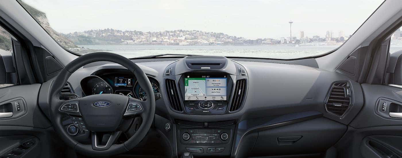 A body of water is seen through the window of the interior of a 2018 Ford Escape.
