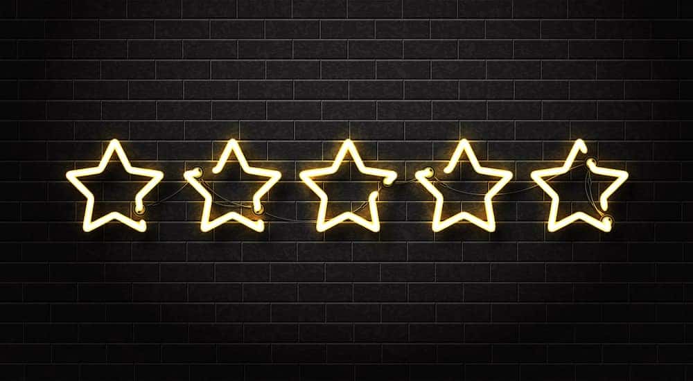 Five LED stars on a black brick wall to represent DePaula Ford, a Ford Dealership near Troy, NY