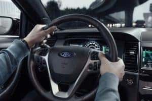 man holding steering wheel in new 2019 Ford Taurus SHO