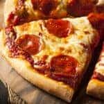 A close up of slices of pepperoni pizza is shown,
