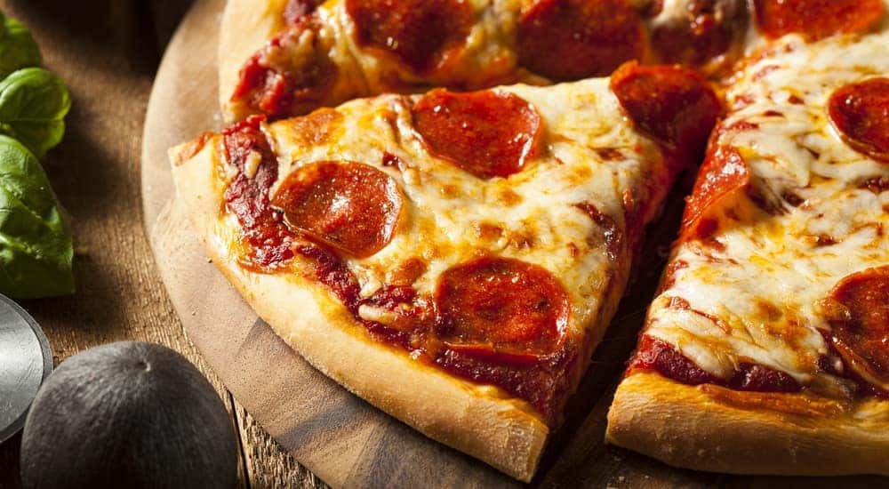 A close up of slices of pepperoni pizza is shown,