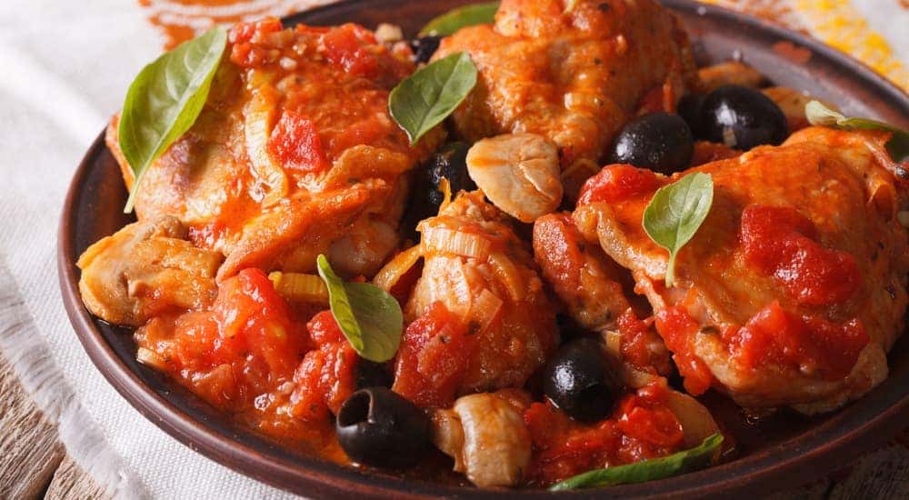 A plate of Pollo Alla Cacciatora is shown.