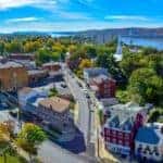 A vibrant aerial shot of the Poughkeepsie, NY skyline is shown.