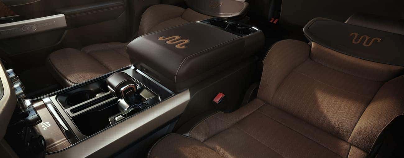 The brown front seats in a 2021 Ford F-150 are in a full recline position.