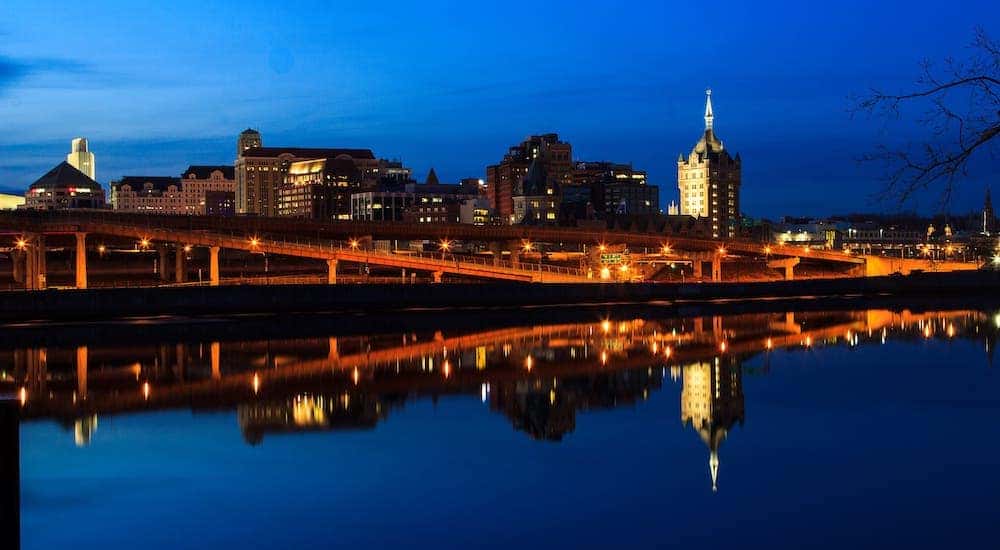 The Albany, NY, skyline is shown at night from across the river.
