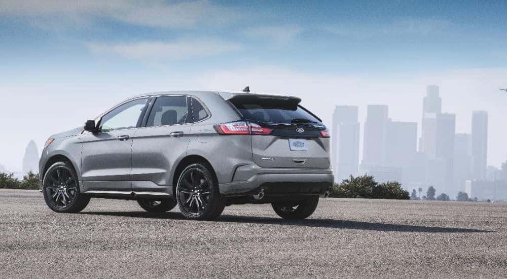 Silver 2020 Ford Edge SUV parked diagonally with tall buildings in the background