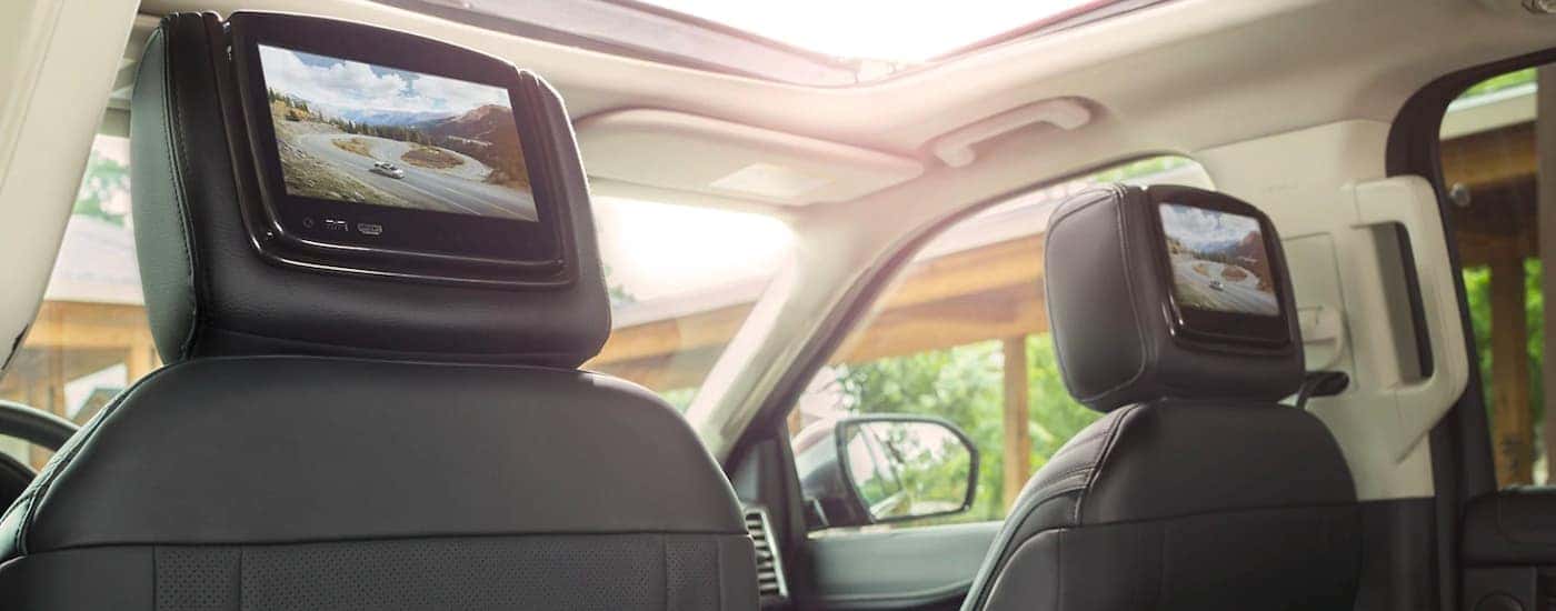 The black interior and head rest screens are shown in a 2021 Ford Expedition.