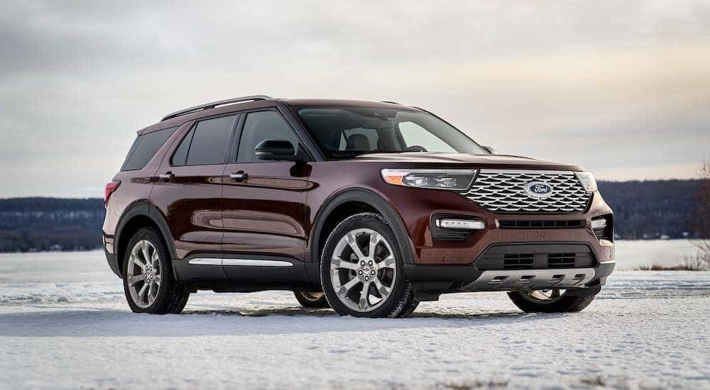 A burgundy 2021 Ford Explorer Platinum is parked on snow.