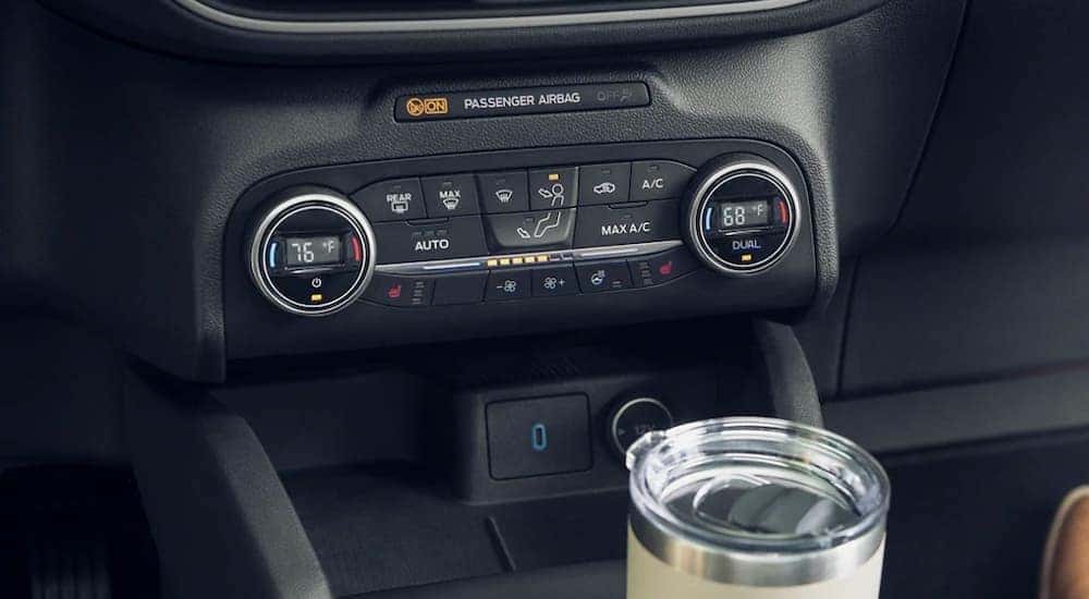 The buttons and climate controls are shown on a 2021 Ford Escape.