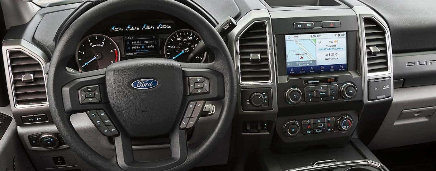 The steering wheel and infotainment screen are shown on a 2021 Ford Chassis Cab.