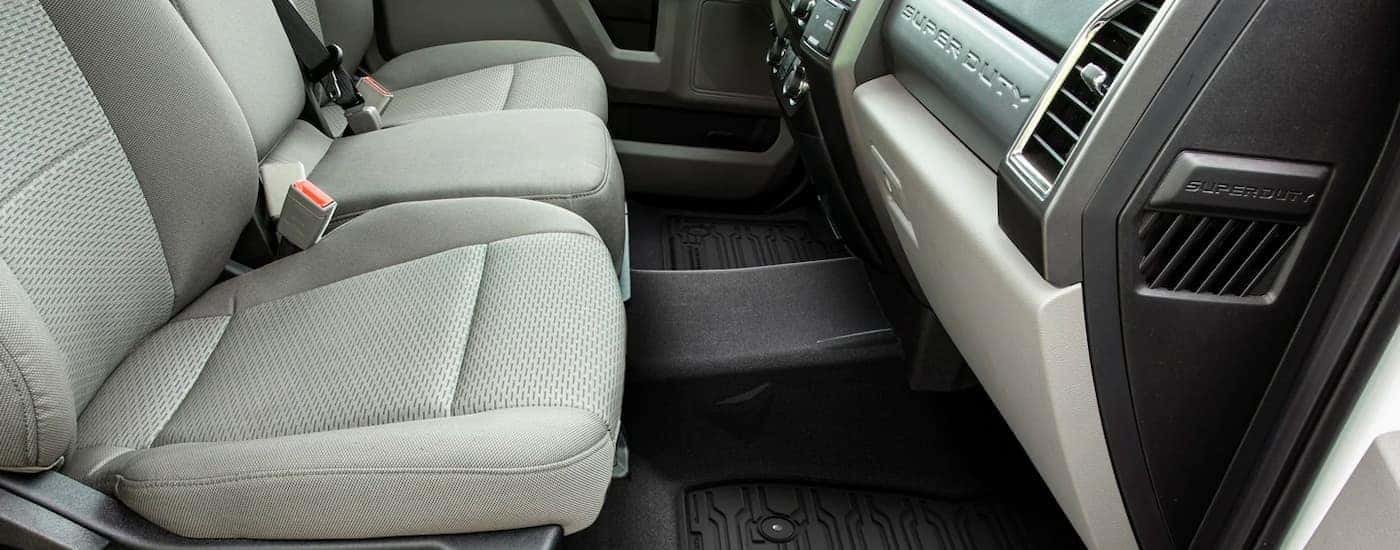 The gray interior and front seats are shown from the passenger side on a 2021 Ford Chassis Cab.