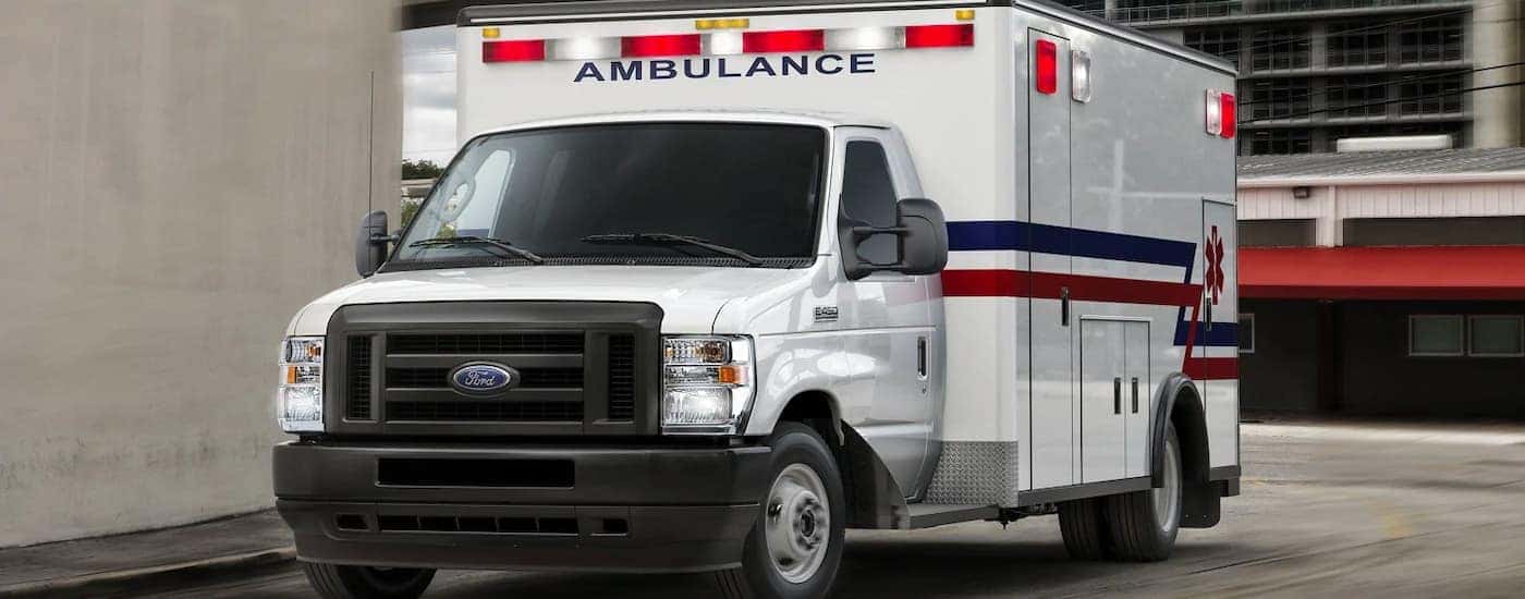 A white 2022 Ford E-Series Cutaway is shown with an ambulance body.