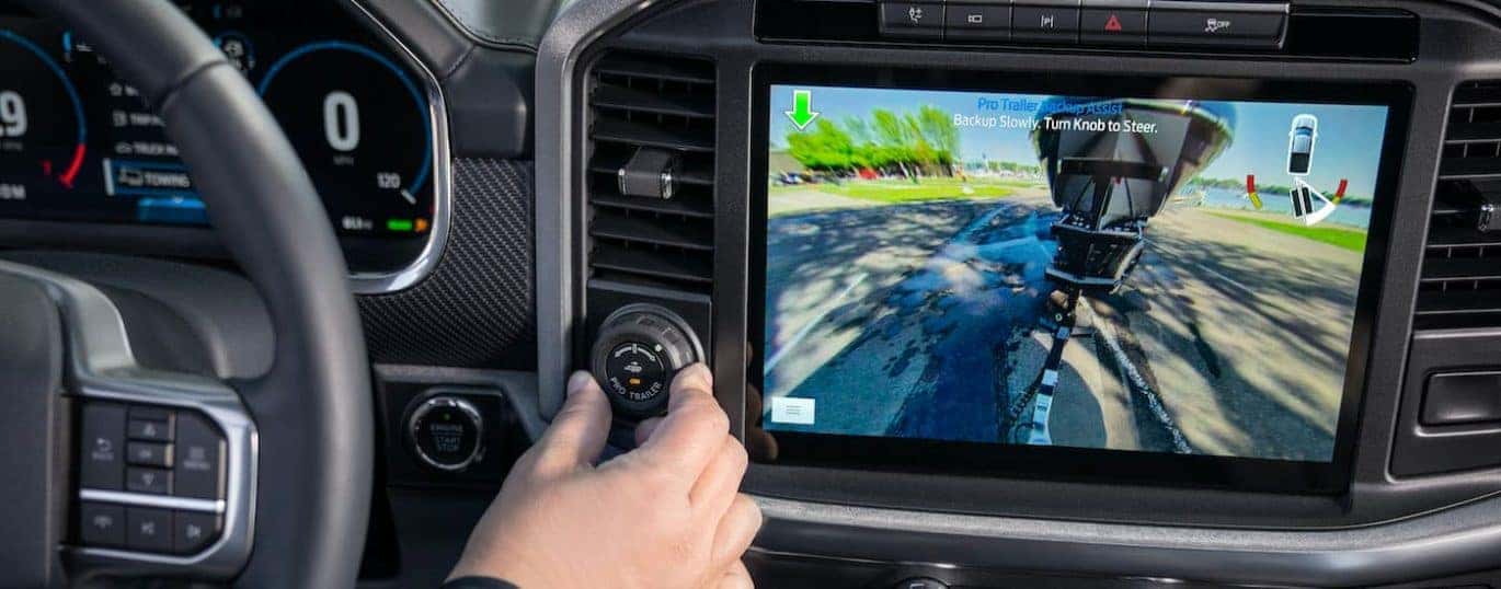 A close up shows the infotainment screen and back up camera view in a 2021 Ford F-150.