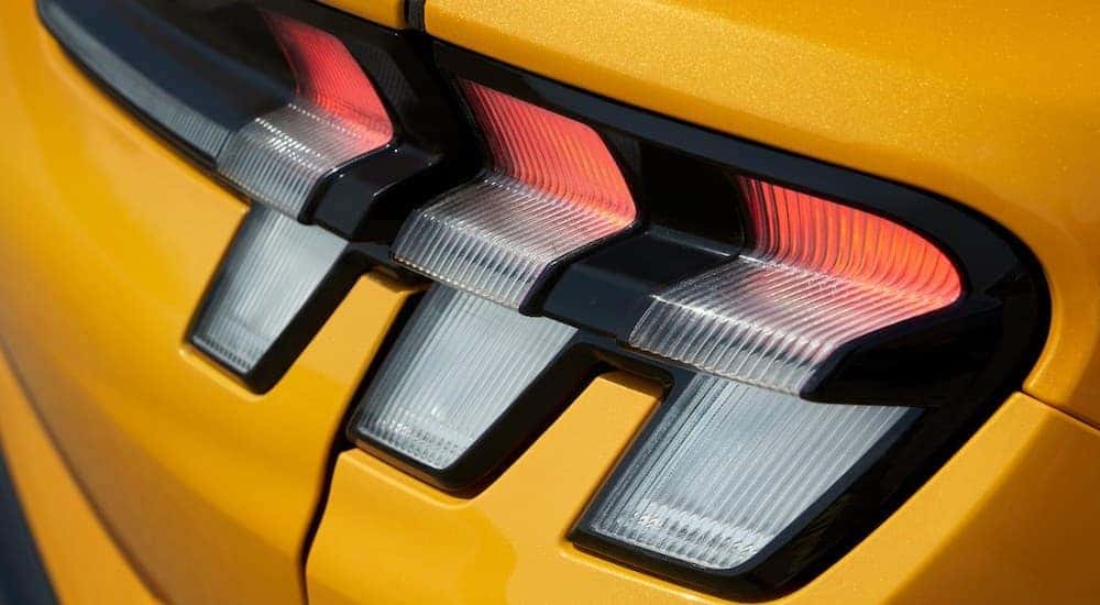 A close up shows the passanger tail light on a yellow 2021 Ford Mustang Mach-E GT.