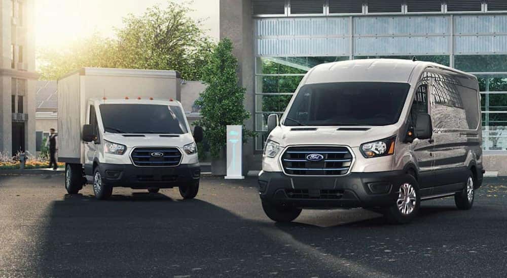 Two 2022 Ford E-Transits are parked outside of the electric car dealer in Albany.