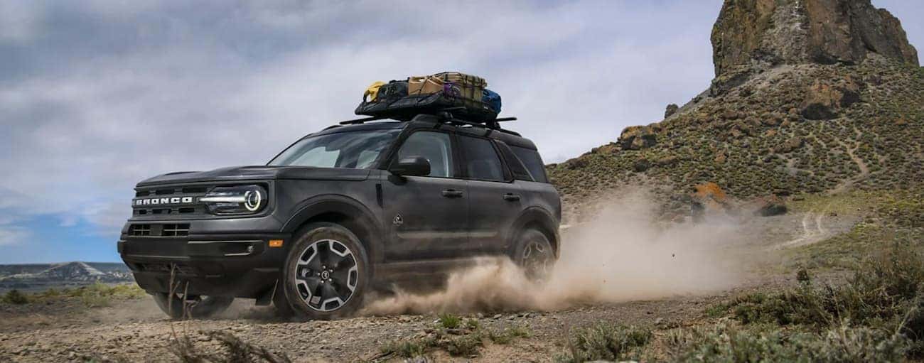 A grey 2021 Ford Bronco Sport is shown off-roading in the desert during a 2021 Ford Bronco Sport vs 2021 Subaru Crosstrek comparison.