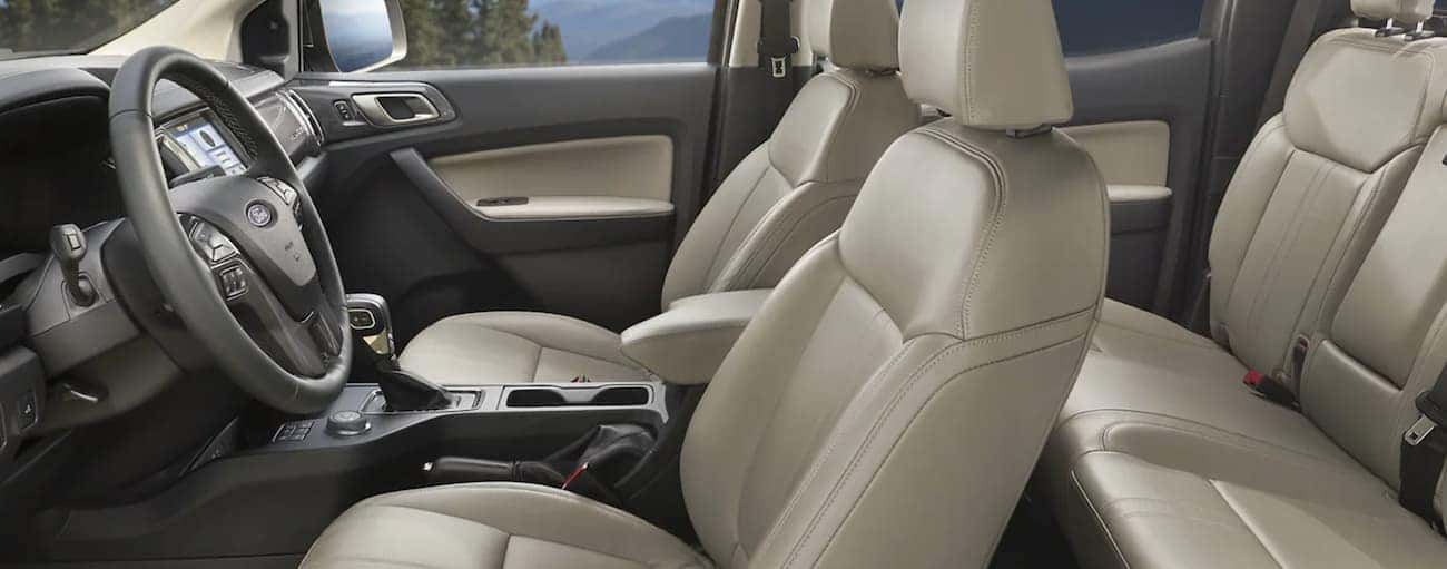 The interior of a 2021 Ford Ranger shows two rows of seating and the steering wheel.