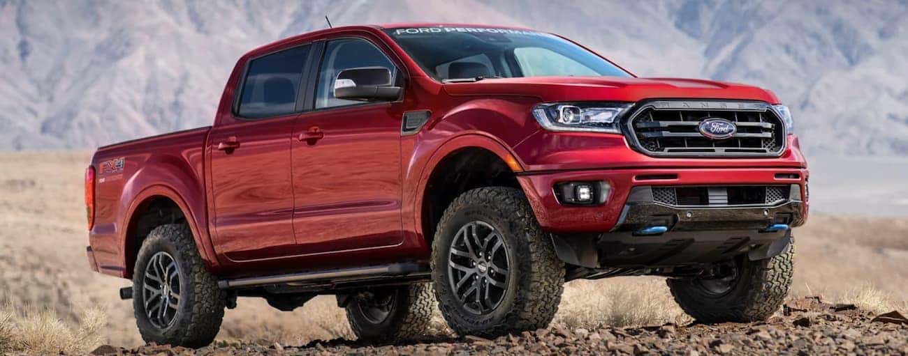 A red 2021 Ford Ranger is parked in a desert during a 2021 Ford Ranger vs 2021 Toyota Tacoma comparison.