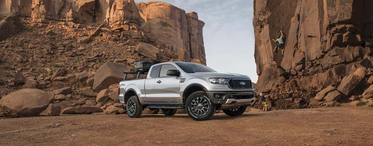 A silver 2021 Ford Ranger is shown from the side parked in a rocky desert.
