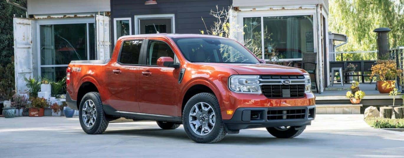 A red 2022 Ford Maverick Lariat is shown parked in a driveway.