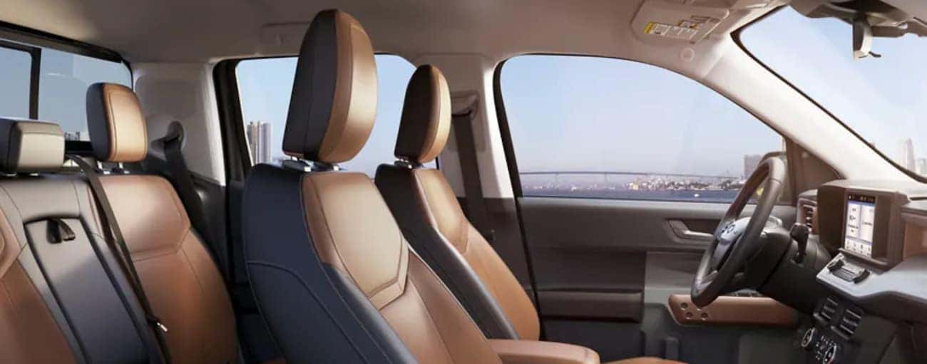 The interior of a 2022 Ford Maverick shows two rows of seating and a steering wheel.