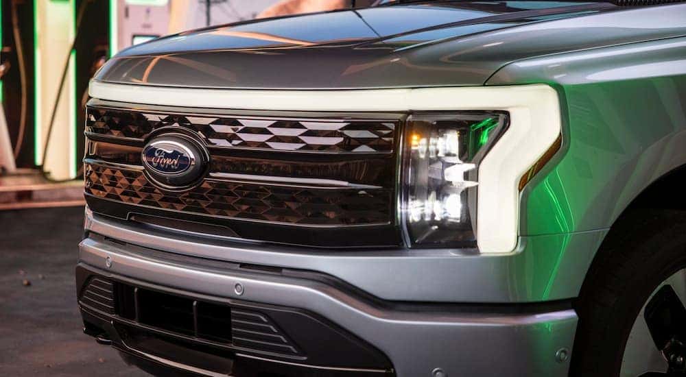 A close up of the grille of a 2021 Ford Lightning is shown at a Ford pre-order dealer.