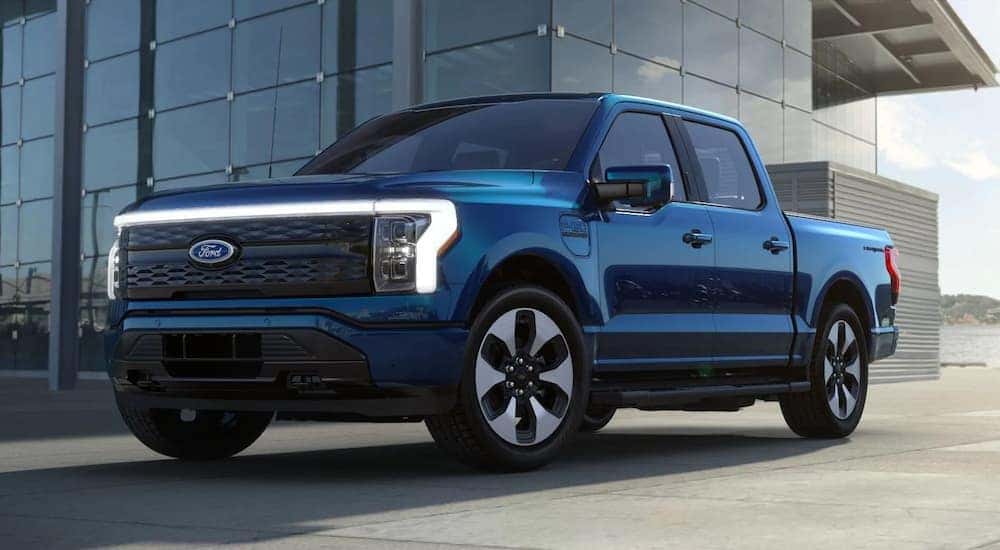 A blue 2022 Ford F-150 Lightning is shown during the reserve a Ford process.