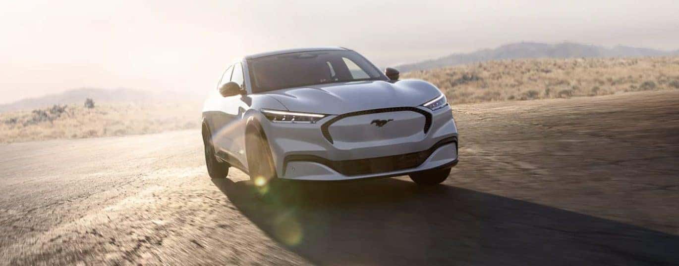 A white 2022 Ford Mustang Mach-E is shown from the front.