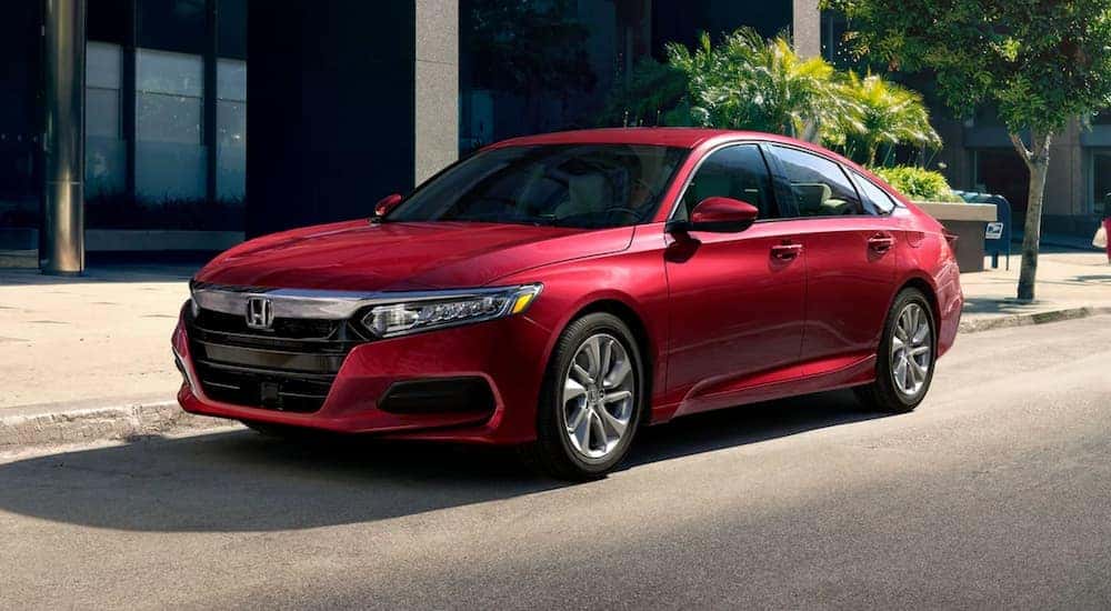 A red 2020 Honda Accord LX is shown parked on the side of a city street after leaving a used car dealership in Albany.