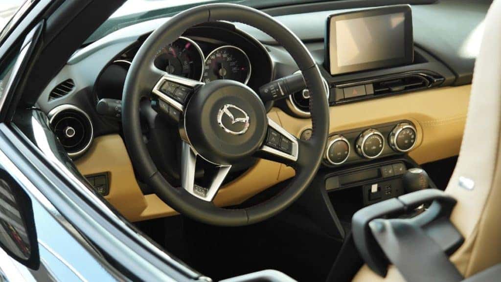 black and tan interior of a new Mazda car showing the Mazda Connect infotainment center