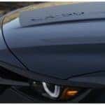 closeup of a black hood and bumper of a Mazda vehicle