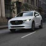 White Mazda CX-50 Driving Down the Road