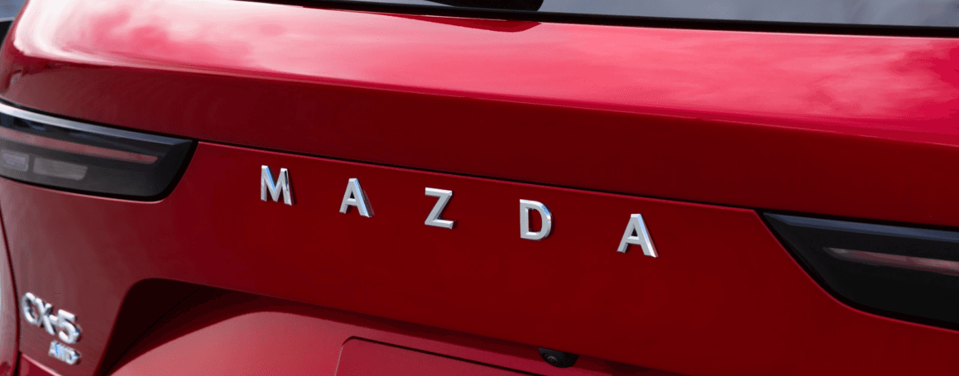 Chrome Mazda badging on the rear of a red 2026 Mazda CX-5