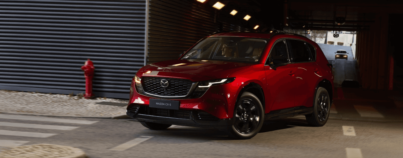 Red 2026 Mazda CX-5 driving through a city