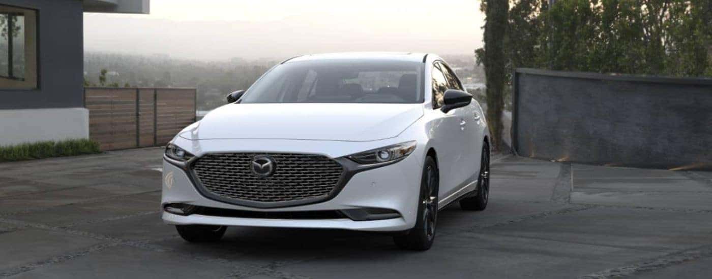 White 2026 Mazda3 parked in a driveway.