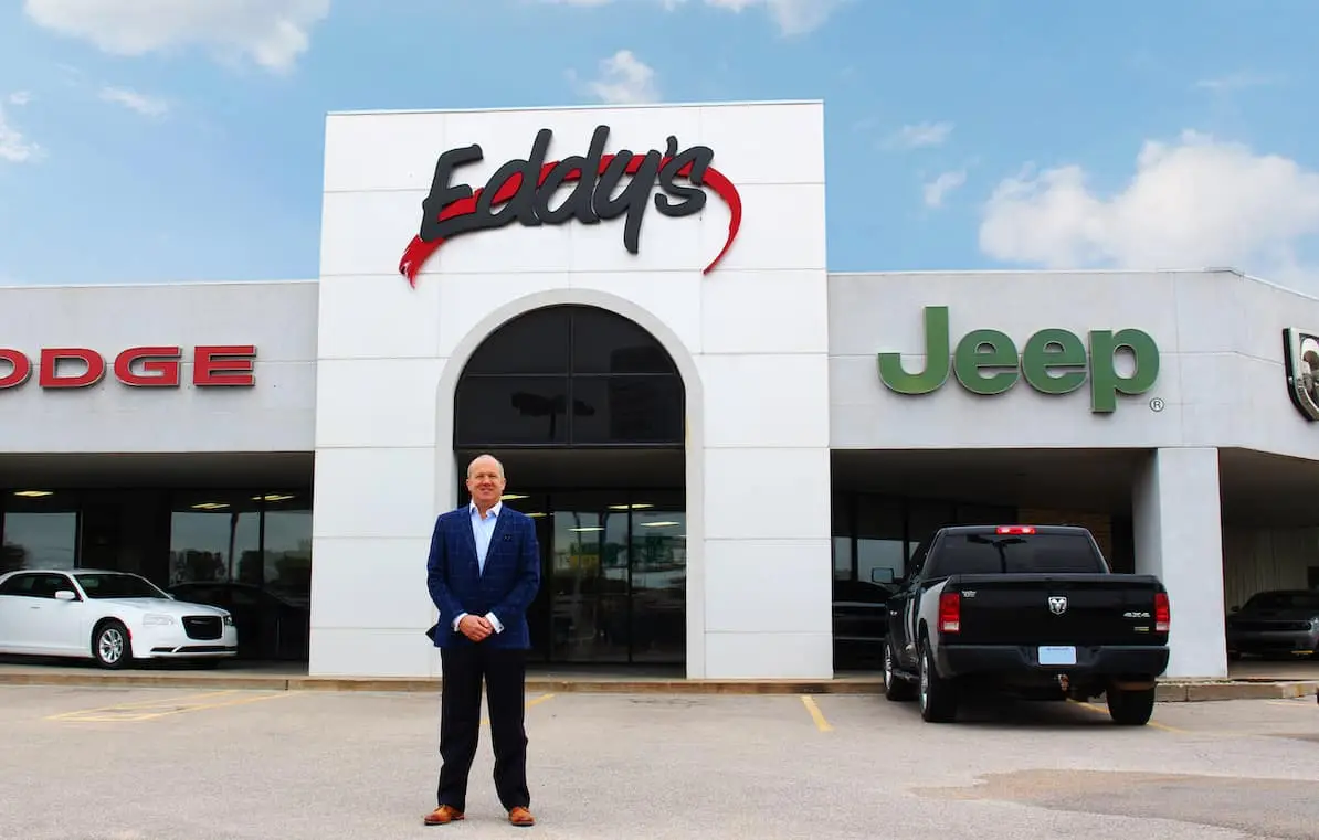 Man standing in front of dealership