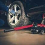 Car mechanic rotating tire
