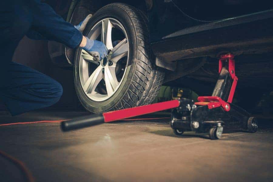 Car mechanic rotating tire