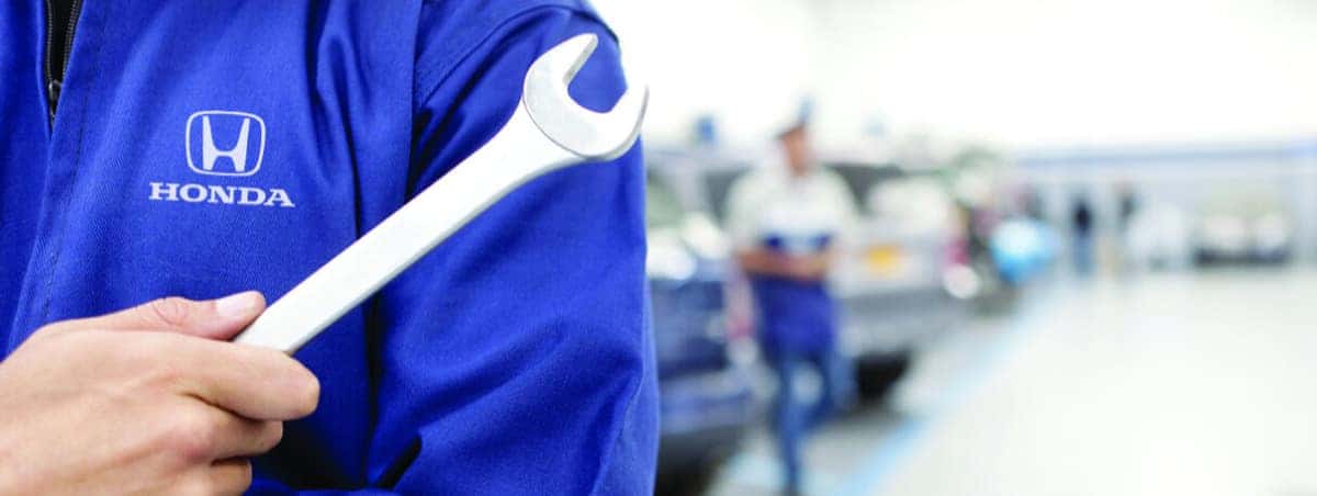 Honda service tech holding wrench