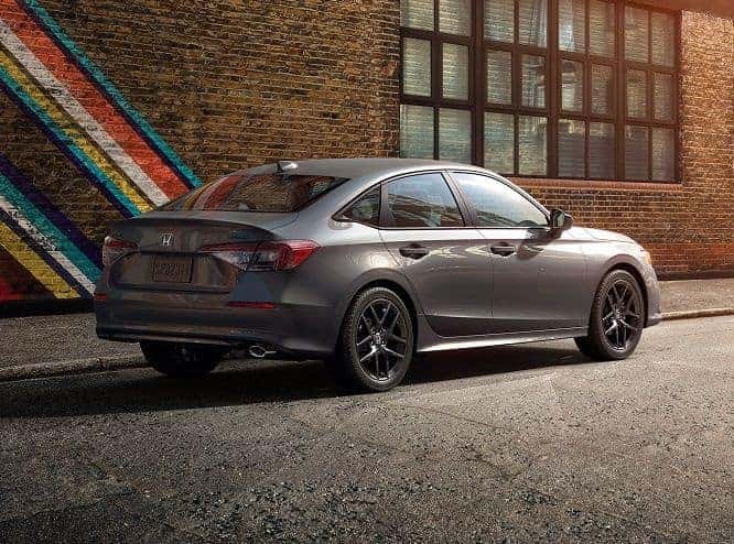 2026 Honda Civic Sport sedan in Meteorite Gray Metallic, rear three-quarter view