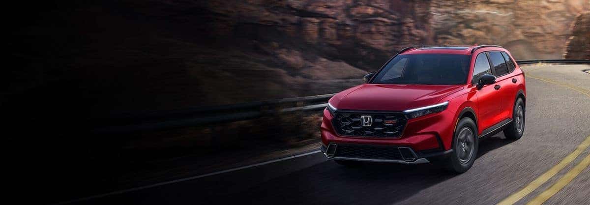 2026 Honda CR-V TrailSport Hybrid front three-quarter view in Radiant Red Metallic
