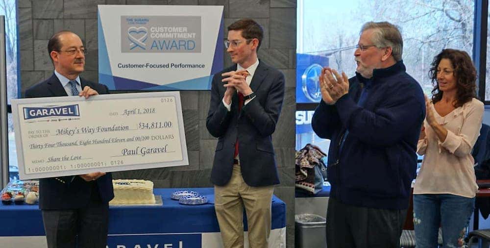 Garavel presenting check